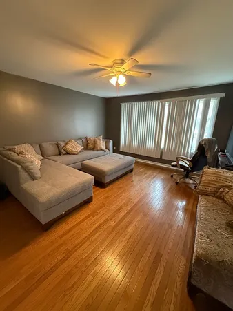 a bedroom with furniture and a wooden floor