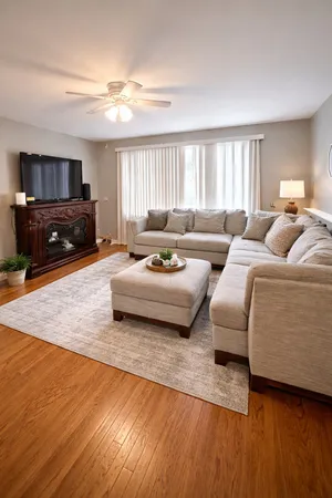 a living room with furniture window and a wooden floor