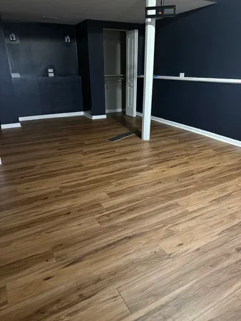 an empty room with wooden floor