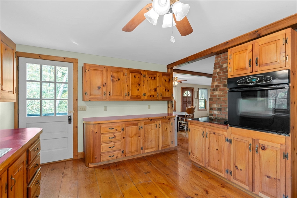 362 Snows Pond Road Rochester, MA 02770 - Photo 11 of 41 a kitchen with stainless steel appliances granite countertop a stove a sink and a microwave oven with white cabinets