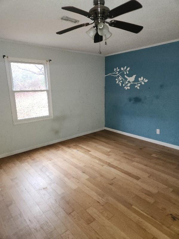 60 Zion Hill Road Marion, NC 28752 - Photo 8 of 19 an empty room with wooden floor chandelier fan and windows
