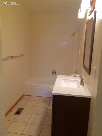 4415 Beaumont Road Colorado Springs, CO 80916 - Photo 26 of 29 Upper bathroom, tile, new vanity, light.