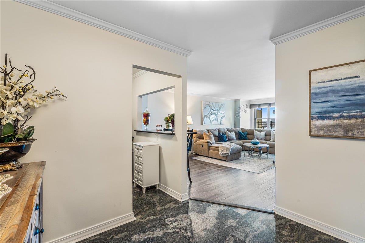 17-85 215th Street, Unit 16J Queens, NY 11360 - Photo 12 of 28 a view of living room filled with furniture and a potted plant