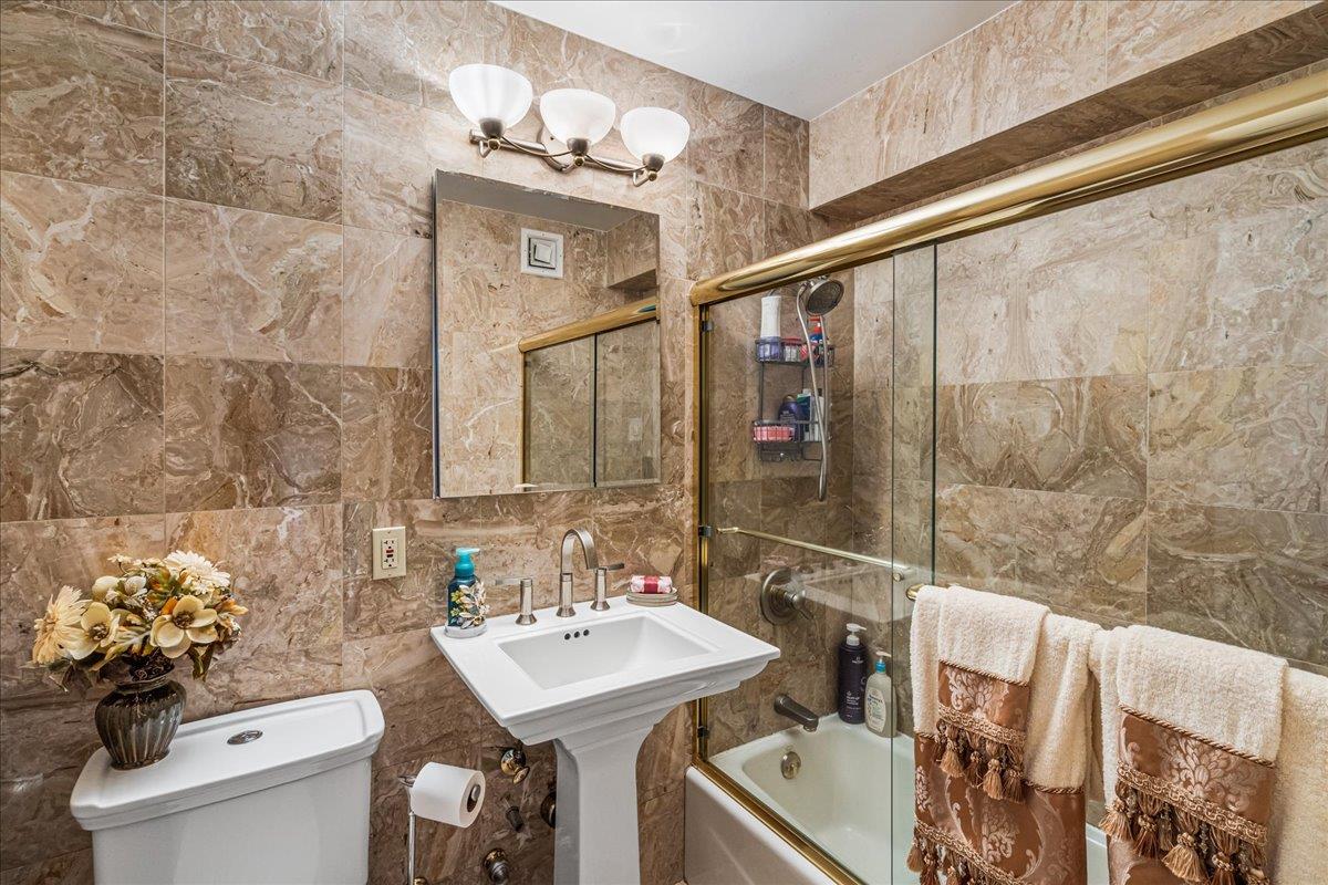 17-85 215th Street, Unit 16J Queens, NY 11360 - Photo 13 of 28 a bathroom with a sink toilet and shower