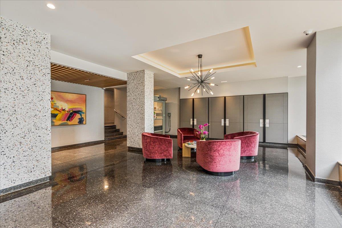 17-85 215th Street, Unit 16J Queens, NY 11360 - Photo 18 of 28 a living room with furniture a window and a ceiling fan