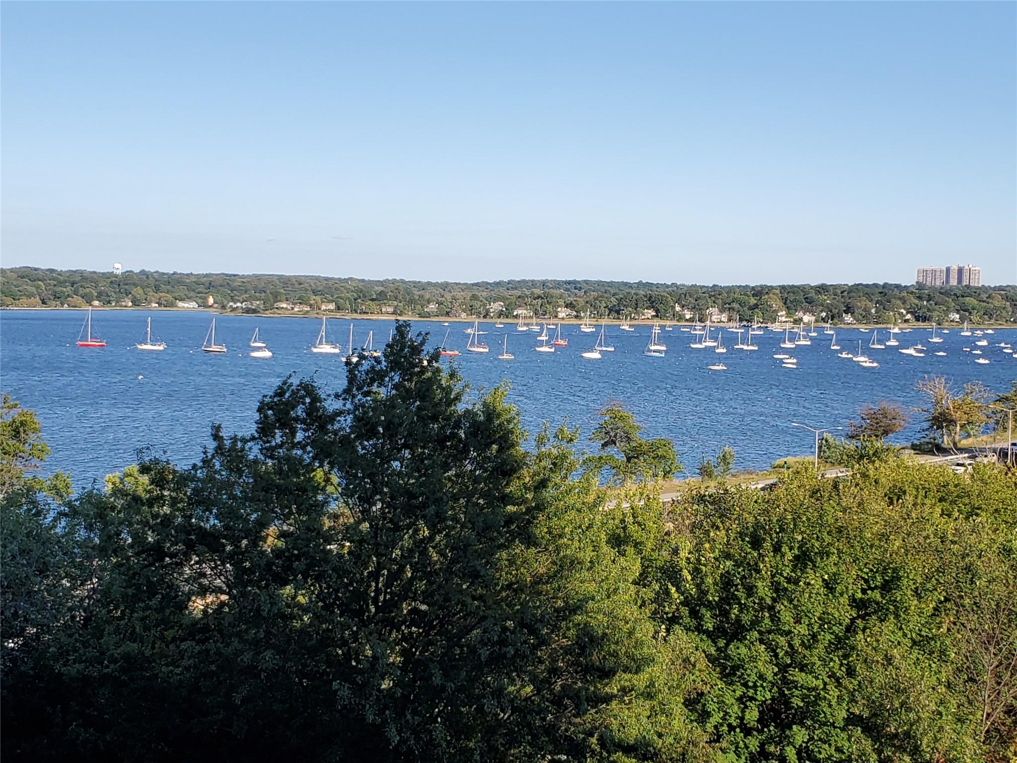 17-85 215th Street, Unit 16J Queens, NY 11360 - Photo 25 of 28 an aerial view of ocean and residential houses with outdoor space and trees