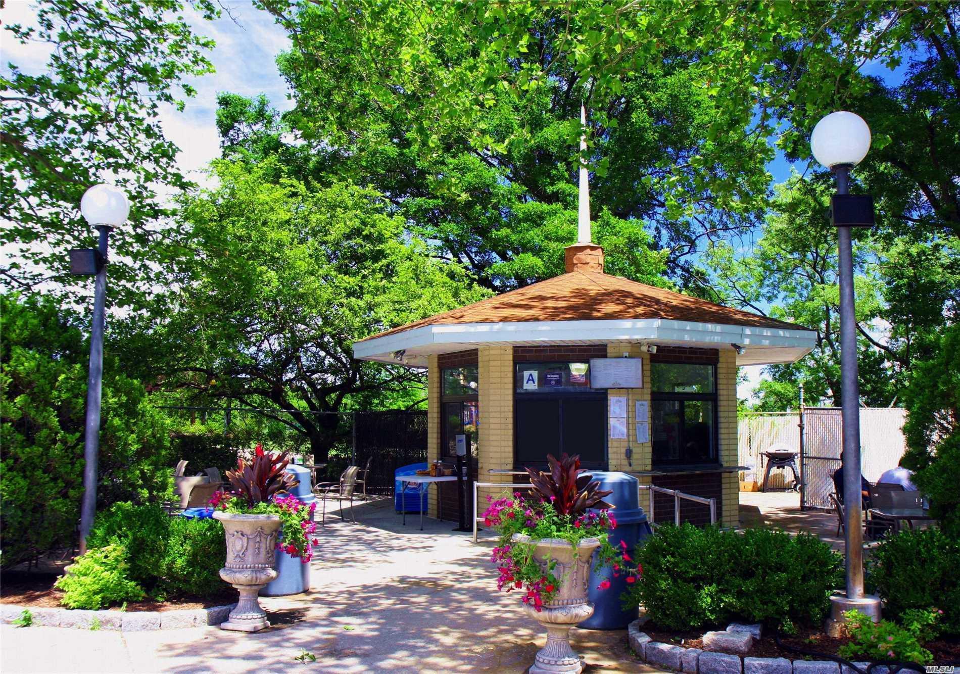 17-85 215th Street, Unit 16J Queens, NY 11360 - Photo 26 of 28 a view of a table and chairs in patio with a fire pit