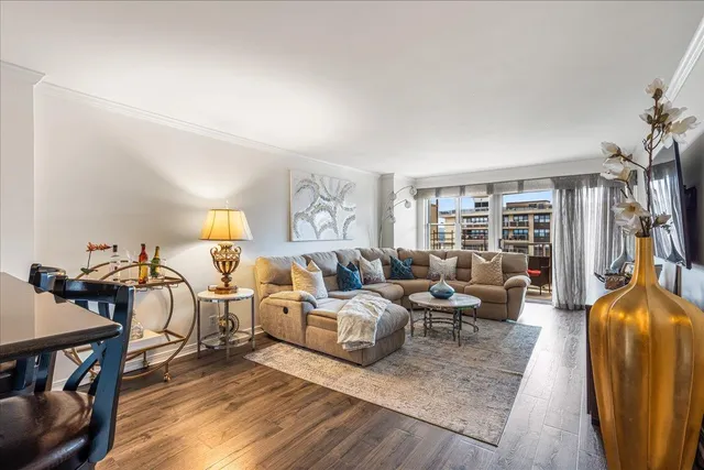 a living room with lots of furniture and a wooden floor