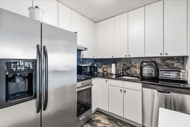 a view of living room filled with furniture and a potted plant