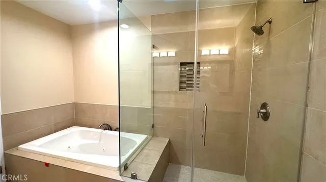 a bathroom with a tub and shower