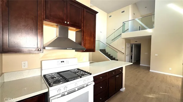a kitchen with a sink a stove and cabinets