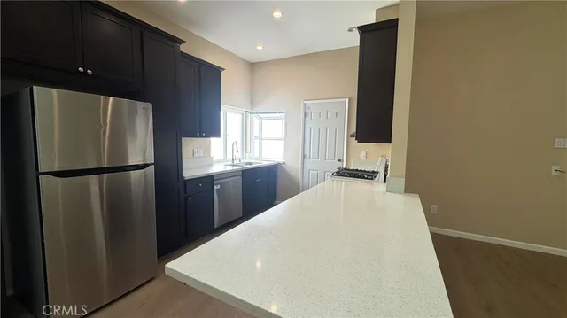 a kitchen with stainless steel appliances a refrigerator and a stove
