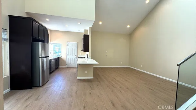 a view of a kitchen with wooden floor and a space