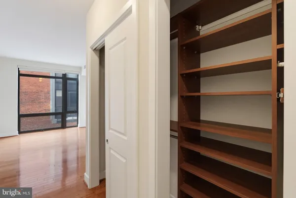 a view of walk in closet with empty racks