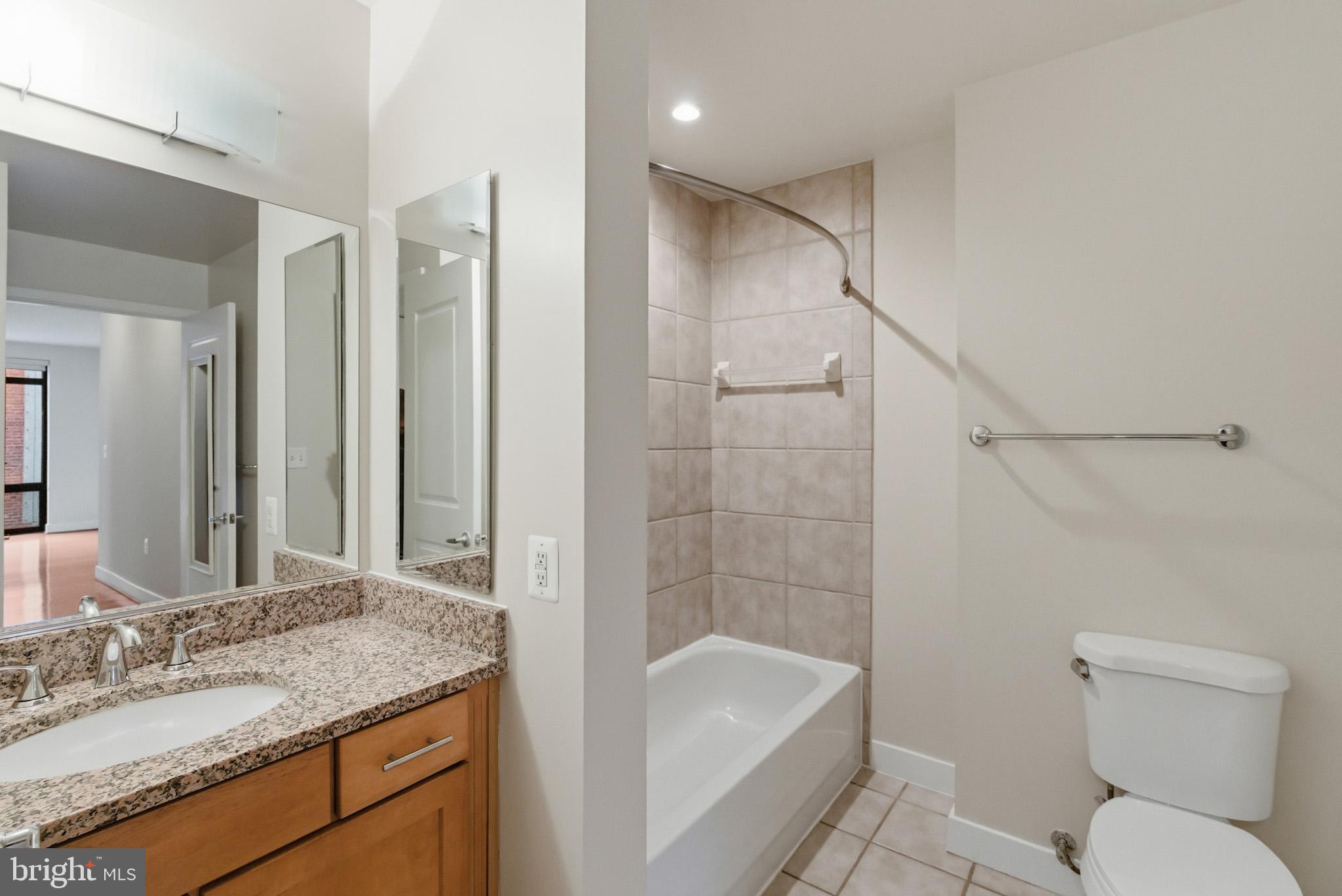1211 13th Street Northwest, Unit 206 Washington, DC 20005 - Photo 15 of 22 a bathroom with a granite countertop sink toilet and shower
