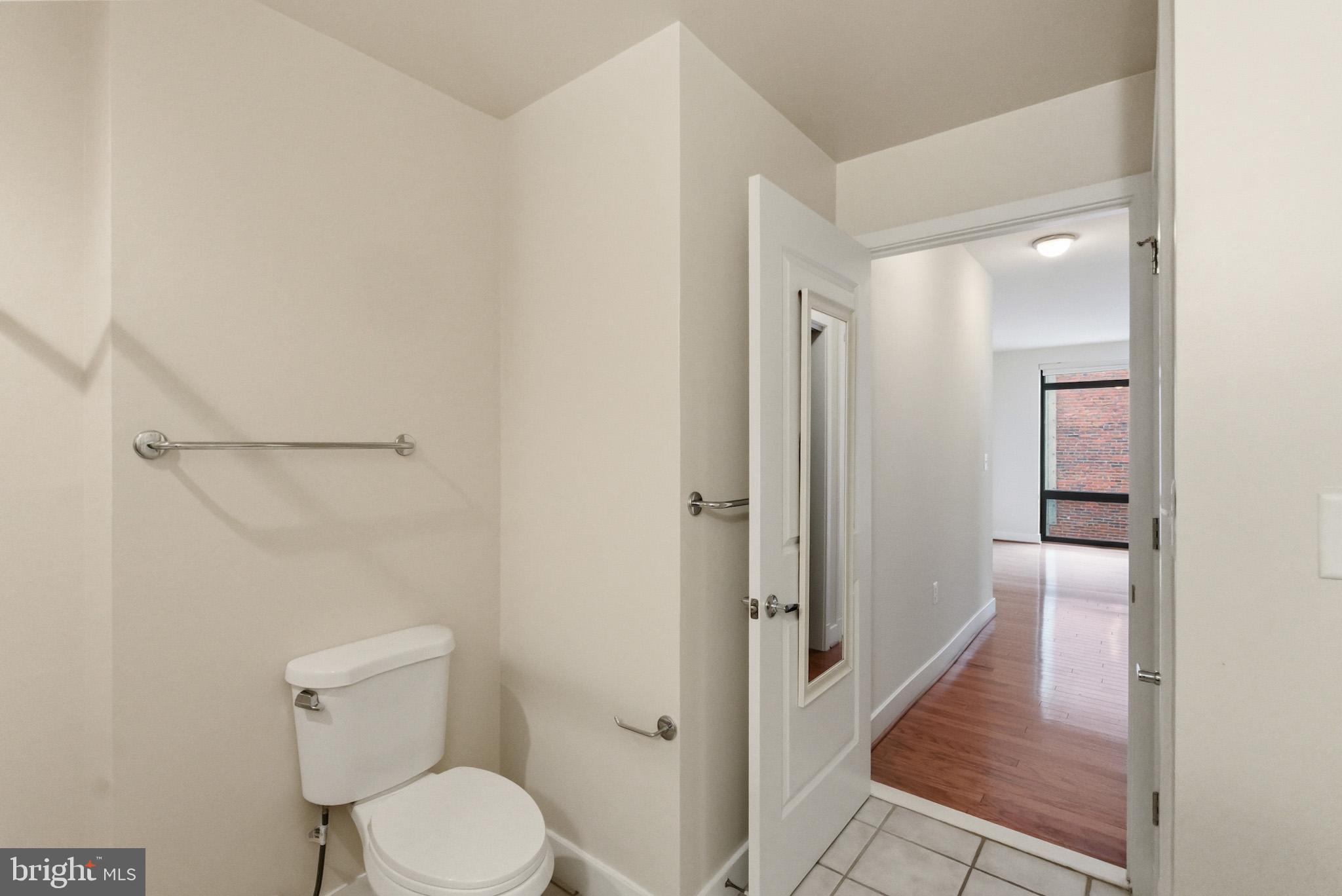 1211 13th Street Northwest, Unit 206 Washington, DC 20005 - Photo 16 of 22 a bathroom with a granite countertop toilet and a shower