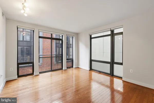 an empty room with wooden floor and sliding door