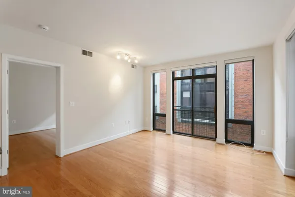 a view of an empty room with glass door