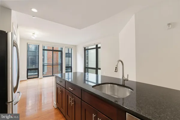 a kitchen with granite countertop a sink and cabinets
