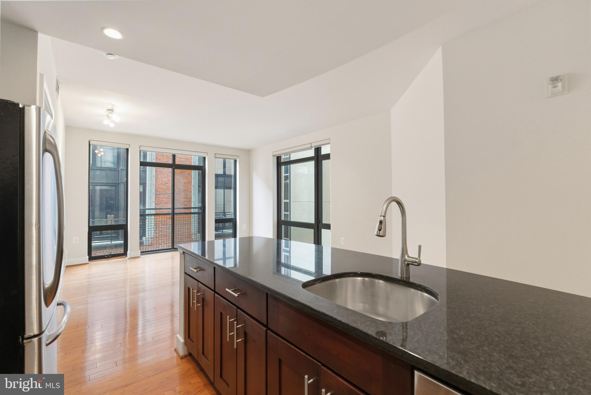 1211 13th Street Northwest, Unit 206 Washington, DC 20005 - Photo 5 of 22 a kitchen with granite countertop a sink and cabinets