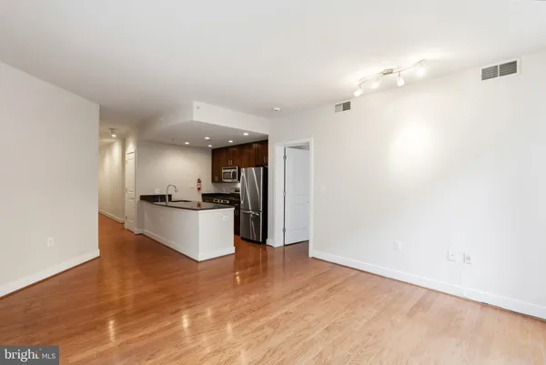 a large kitchen with cabinets and stainless steel appliances