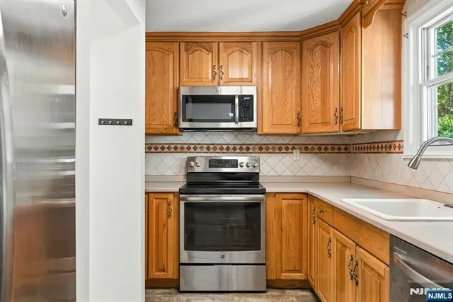 a kitchen with a stove microwave and sink