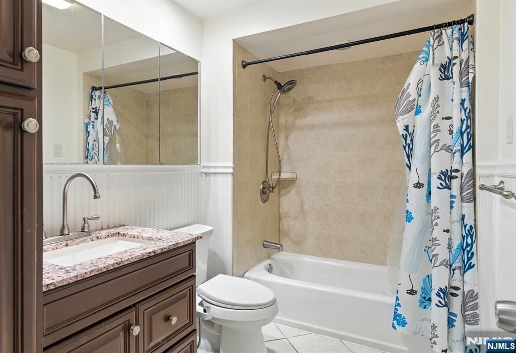 42 Meadow Lane Bloomfield, NJ 07003 - Photo 14 of 37 a bathroom with a granite countertop sink a toilet and a bathtub