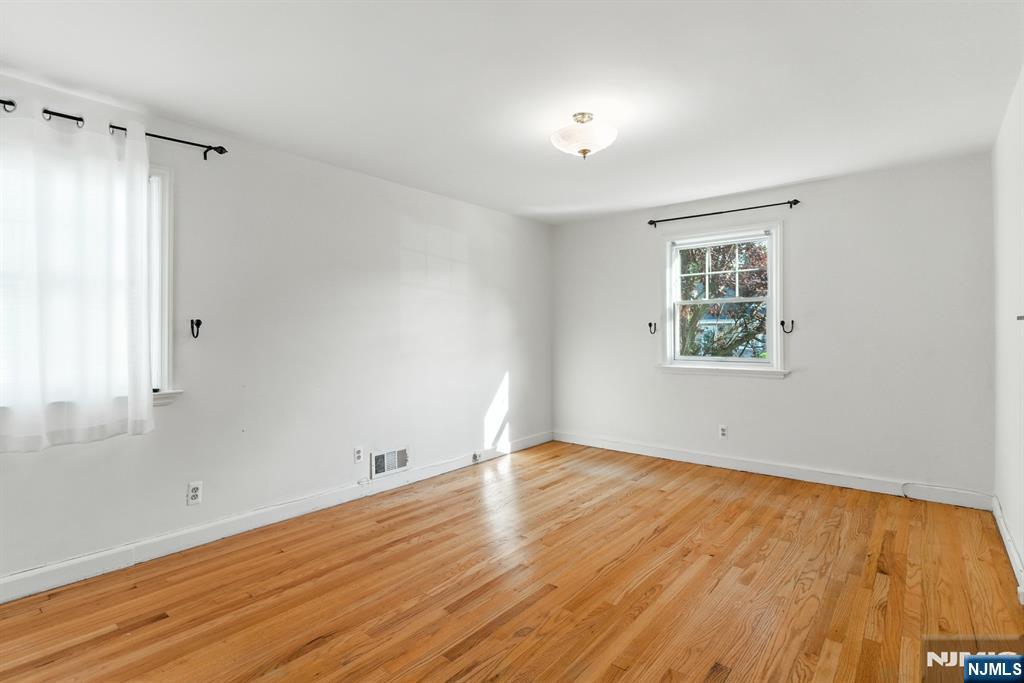 42 Meadow Lane Bloomfield, NJ 07003 - Photo 15 of 37 an empty room with wooden floor and windows