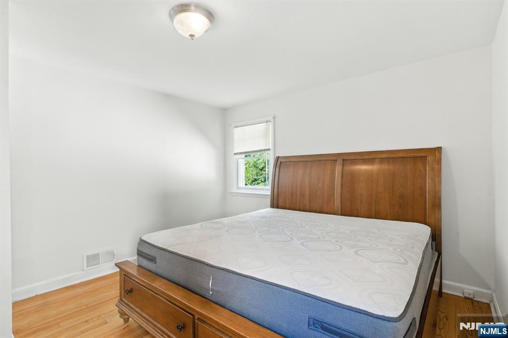 42 Meadow Lane Bloomfield, NJ 07003 - Photo 17 of 37 a bedroom with a bed and wooden floor
