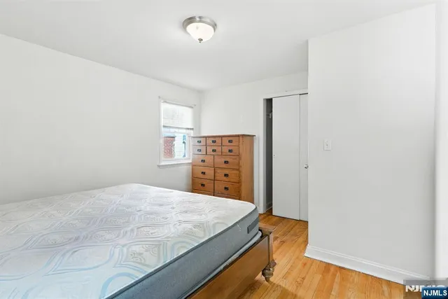 a bedroom with a bed and dresser