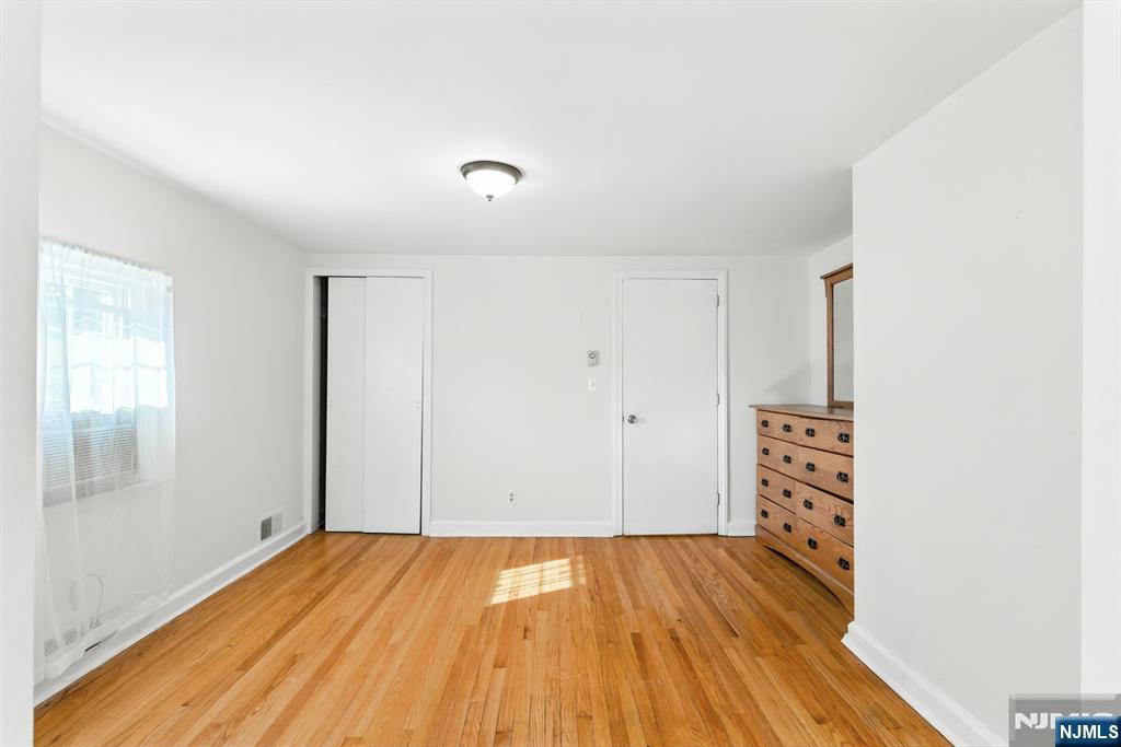 42 Meadow Lane Bloomfield, NJ 07003 - Photo 21 of 37 an empty room with wooden floor and windows