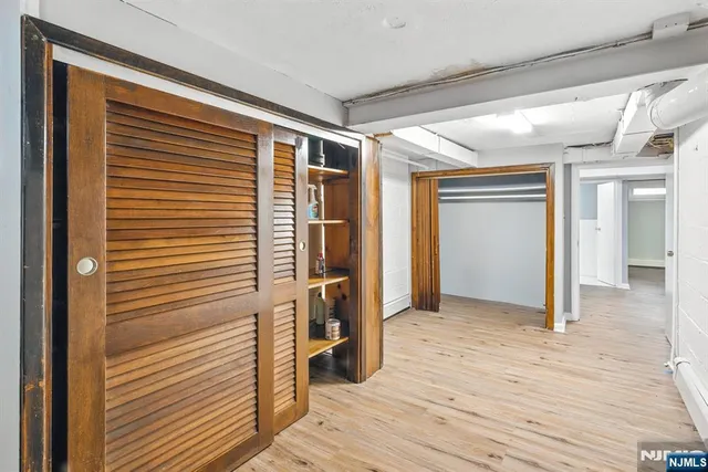 a view of hallway with wooden floor