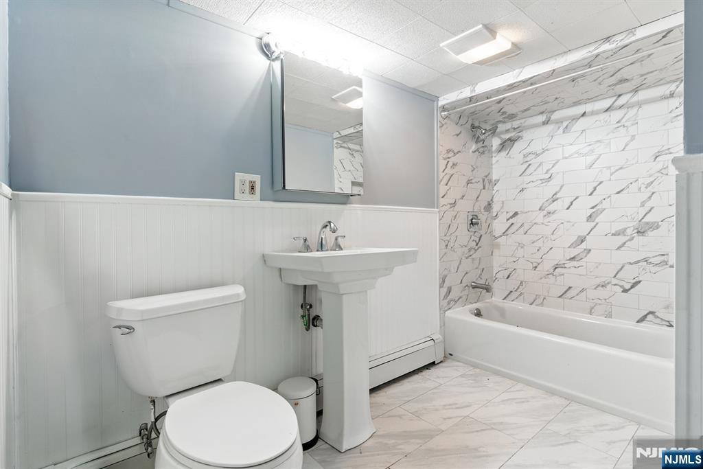 42 Meadow Lane Bloomfield, NJ 07003 - Photo 29 of 37 a bathroom with a sink a toilet and shower