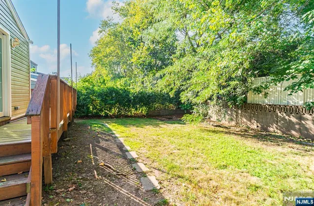 a backyard of a house with yard and outdoor seating