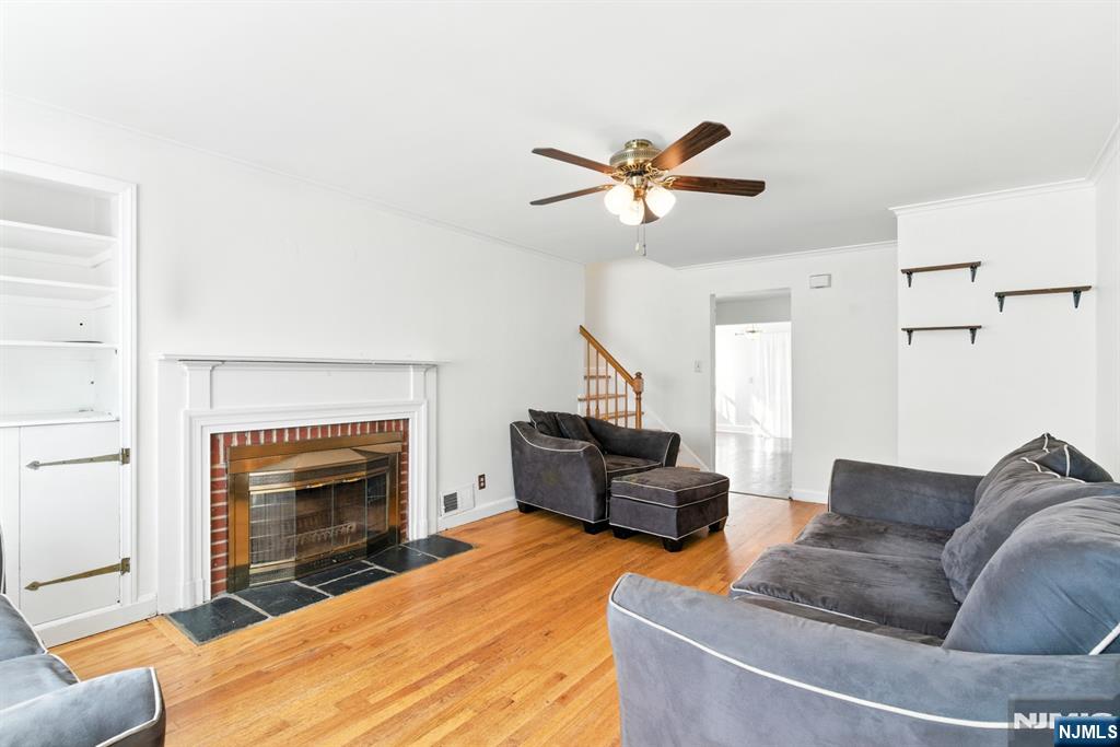42 Meadow Lane Bloomfield, NJ 07003 - Photo 4 of 37 a living room with furniture and a fireplace