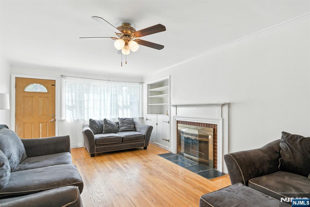 42 Meadow Lane Bloomfield, NJ 07003 - Photo 5 of 37 a living room with furniture a flat screen tv and a fireplace