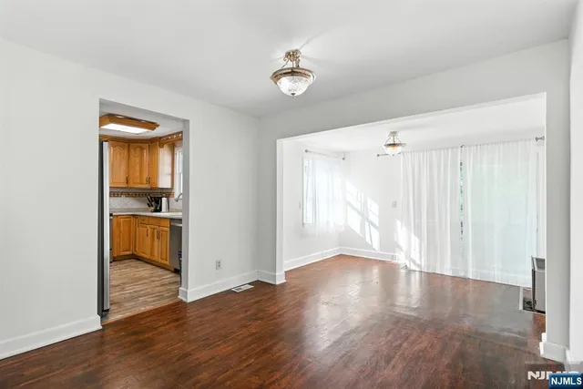 a view of a room with wooden floor and a window
