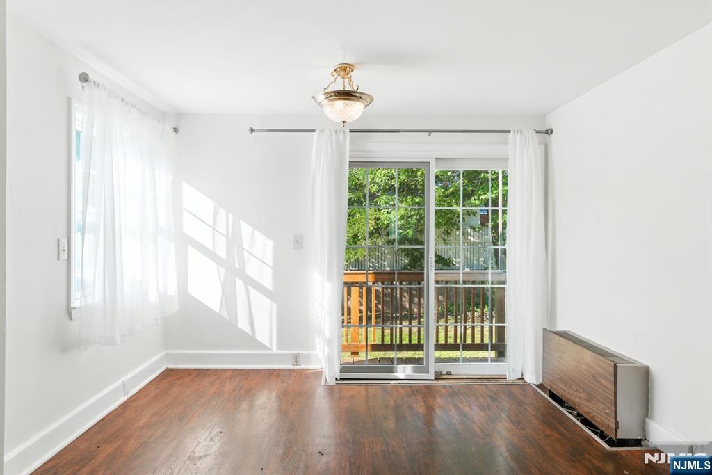 42 Meadow Lane Bloomfield, NJ 07003 - Photo 10 of 37 a view of an empty room with a window and wooden floor
