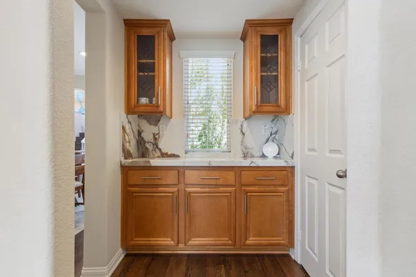 a view of a kitchen with kitchen island stainless steel appliances a stove a sink a refrigerator and cabinets