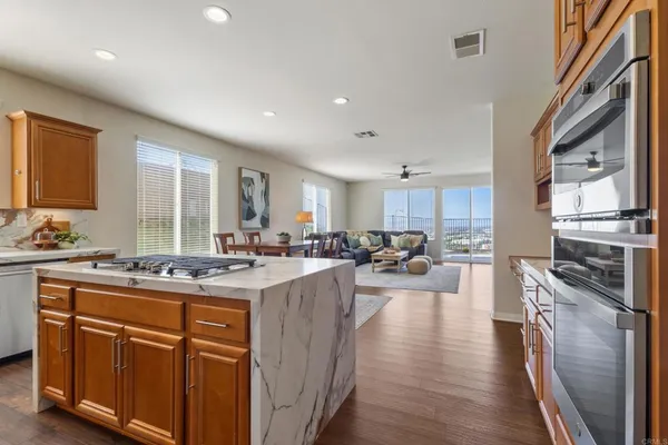 a living room with furniture a fireplace and a floor to ceiling window