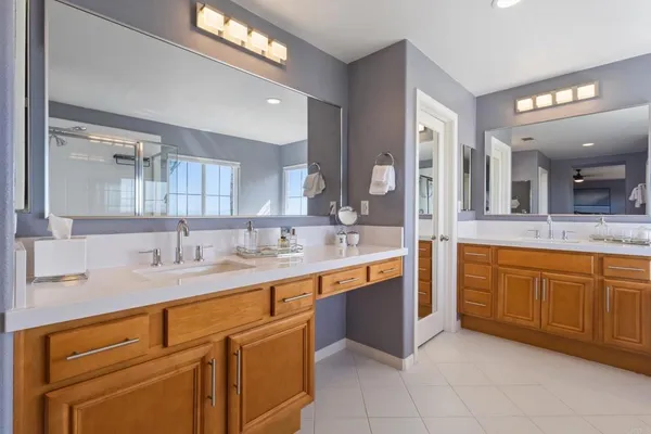 a bathroom with a toilet sink vanity and mirror