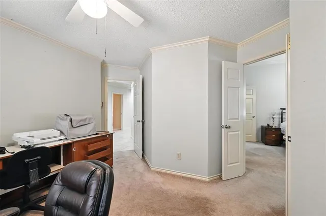 a view of a hallway with workspace and a couch