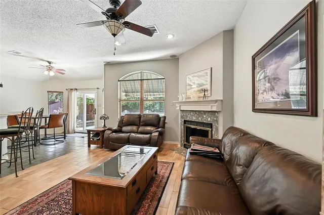 a living room with furniture a large window and a fireplace