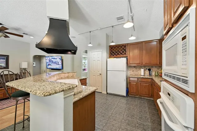 a kitchen with a stove a refrigerator and a sink