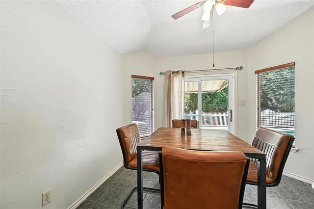 a dining room with furniture a chandelier and wooden floor