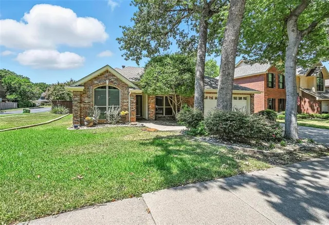 a front view of a house with a yard table and chairs
