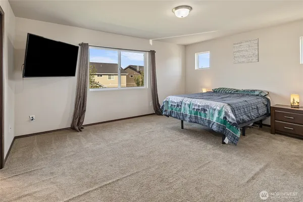 a room with a bed and a flat screen tv