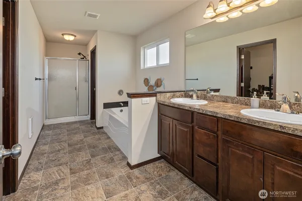 a spacious bathroom with a granite countertop sink mirror and a