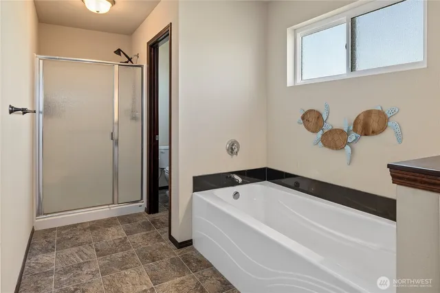 a bathroom with a bathtub and a shower