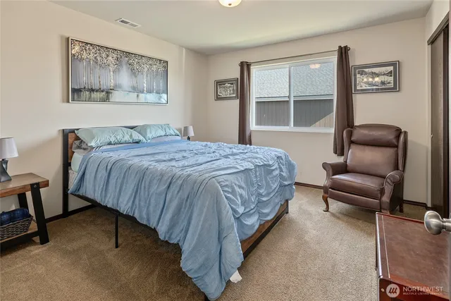 a bedroom with a bed couch and window